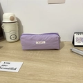 Close-up of purple fabric pencil case with Mayrabbit logo on a light wooden desk - 19x6x7cm / Purple