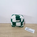 Detail of green and white checkerboard plush pouch with soft faux fur and brand label - Plush Checkerboard Green Grid
