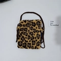 Detail view of leopard print plush mini crossbody bag with dark brown woven strap - Khaki Small Leopard