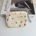 Detailed macro view of cream floral cotton pouch with colorful dots and blue cord handle - Colorful Polka Dots