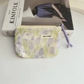 Detail of floral canvas coin purse with May Rabbit label and lavender zipper pull strap - Rabbit Tulip Blue Green