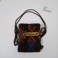 Detail of plush crossbody bag with orange and blue bohemian geometric pattern and woven strap - Retro Figure