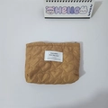 Detailed view of yellow quilted heart patterns and zip closure on the cosmetic pouch - Brown