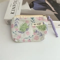 Detailed macro view of mint floral fabric coin purse with May Rabbit woven label - Galsang Flower Green