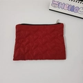 Close-up of red heart-quilted mini storage bag with premium silver metal zipper - Burgundy