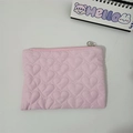 Detail of pink quilted heart texture cosmetic pouch with durable silver metal zipper closure - Pink