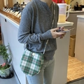 Retro green plaid oval crossbody bag with vintage checkered pattern and button closure - Red and Green Plaid (Brushed) Egg Bag