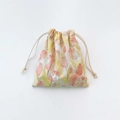 Detail of tulip printed canvas jewelry pouch with white drawstring on white background - Yellow & Green