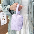 Close-up of heart-quilted lavender cosmetic bag with a soft texture and zipper handle - Purple