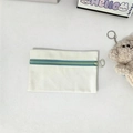 Detail of canvas pouch with dark blue zipper, green ring pull, and plush bear charm - Coin Purse / Green Zipper