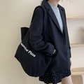Large black canvas tote bag with Famous For Pizza print worn over the shoulder - Black