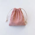 Close-up of pink corduroy texture and white cotton drawstring on a soft storage pouch - Nude Pink