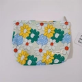 Detail of floral makeup bag with daisy patterns and silver metal zipper closure - Colorful Flowers