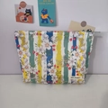 Detailed macro of floral stripe toiletry bag with metal zipper and brand label - Snow Orchid Red Bean