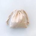 Detailed view of the natural texture and drawstring closure on a beige cotton canvas pouch - Small Storage Bag