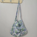 Close-up of floral print cotton tote bag with purple blossoms and green leaves - Violet