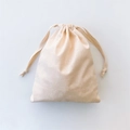 Detailed close-up showing the natural cotton linen texture of the beige drawstring bag - Medium Storage