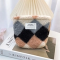 Macro view of plush quilted cosmetic bag with color-block pattern and woven label - Khaki Blue Grid