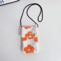Detail view of plush crossbody phone bag with orange floral patterns and woven strap - Orange Flower