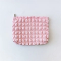 Detail of pink bubble texture fabric on a large capacity cosmetic bag with zip closure - Pink