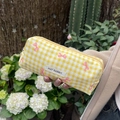 Detail van geel geruit etui met roze strikjes en het label van May Rabbit - Geel