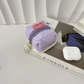 Detailed view of purple quilted earphone pouch with pearl zipper and rabbit tag label - Purple