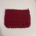 Close-up of deep wine red popcorn fabric cosmetic bag with black zipper closure - Burgundy