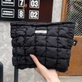 Detail of black quilted puffer cosmetic bag featuring a white May Rabbit brand label - Black Checkerboard