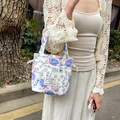 Detailed macro view of floral canvas tote bag featuring rabbit label and blue flower pattern - Blue Floral