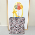 Detail of floral pattern tote bag with yellow handles and navy blue inner lining - SHINE Purple Floral