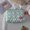 Detail of mint green heart-quilted pouch with a pink checkered bow and red loop - Green