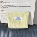 Macro detail of canvas makeup pouch with polka dots and silver zipper closure - Light Yellow Polka Dot