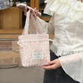 Detailed shot of floral canvas handbag with drawstring closure and rabbit embroidered label - Young Flower