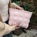 Detail of pink quilted cosmetic bag showing soft puffy texture and zipper closure - Pink Argyle