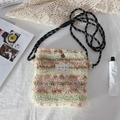 Close-up of plush crossbody bag in pink and green faux fur on white fabric background - Yellow Pink Striped Plush