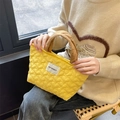 Detail of yellow heart-quilted handbag with brand label and stitched handles - Yellow Heart Brown Strap