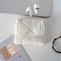 Close-up of white quilted mini storage bag with pink bows and snap button closure - Pink Embroidered Bow