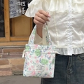 Close-up of floral drawstring canvas bag with May Rabbit logo and pink rose patterns - Gelsang Green Floral