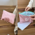 Pink macaron cosmetic pouch with mint green zipper and blue lining in a two-way view - Pink