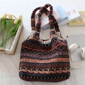 Detail view of ethnic print plush tote bag with snap button closure and soft fleece texture - Plush Orange Blue Stripes