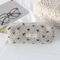 Close-up of soft plush pencil case with heart print and durable zipper detail - Beige Black Small Heart
