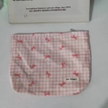 Close-up of floral makeup bag with pink bow pattern and MAY RABBIT label detail - Printed Bow Pink