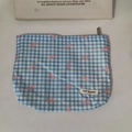 Detailed view of blue checkered makeup bag with pink bow pattern and zipper closure - Printed Bow Blue