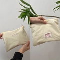 Portable cream macaron nylon pouch with pink zipper and jolly brand label for storage - Beige
