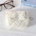 Close-up of cream quilted mini pouch featuring rhombus texture and metal ring zipper - Quilted Pleated Beige White