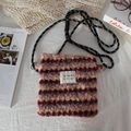 Detail showing plush striped texture and logo patch of the stylish small crossbody bag - Fleece Red Purple Striped