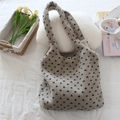 Detail of plush fleece tote bag with navy blue heart pattern in cozy lifestyle setting - Beige Blue Small Heart