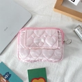 Detailed view of pink quilted heart pouch with snap flap pocket and silver zipper - Pink