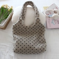 Close-up of plush fleece tote bag with black polka dot pattern in a cozy setting - Beige Black Small Heart
