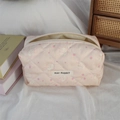 Close-up of pink quilted makeup bag with cute rabbit and strawberry patterns - Pink Strawberry Rabbit